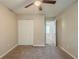 Neutral bedroom featuring carpet floors, a ceiling fan, and an open door to another room at 3897 Mcgill Dr, Decatur, GA 30034
