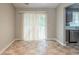 Eat-in kitchen area with sliding glass door, stainless steel dishwasher, and neutral tile flooring at 3897 Mcgill Dr, Decatur, GA 30034