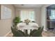 Stylish dining area with a round marble table, seating for four, and a view into the kitchen area at 3897 Mcgill Dr, Decatur, GA 30034