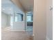 Neutral hallway leading to living areas and the kitchen with a view of the sink and cabinets at 3897 Mcgill Dr, Decatur, GA 30034