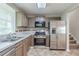 Functional kitchen featuring stainless steel appliances, neutral countertops, and ample cabinet space at 3897 Mcgill Dr, Decatur, GA 30034