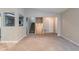 Open-concept living area with view of stairs and kitchen, featuring neutral walls and carpeted floors at 3897 Mcgill Dr, Decatur, GA 30034
