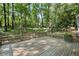 A spacious wooden back deck overlooks a fenced yard and wooded lot at 4628 Mountain Creek Ne Dr, Roswell, GA 30075