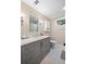 The bathroom features a vanity with drawers, marble tile and modern fixtures at 4628 Mountain Creek Ne Dr, Roswell, GA 30075