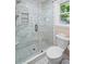 Bathroom featuring a tiled shower stall with glass door and toilet at 4628 Mountain Creek Ne Dr, Roswell, GA 30075