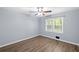 This simple bedroom features wood floors, neutral paint and a ceiling fan at 4628 Mountain Creek Ne Dr, Roswell, GA 30075
