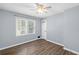 The bedroom features wood floors, a double-hung window, and modern paint at 4628 Mountain Creek Ne Dr, Roswell, GA 30075