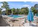 Community pool surrounded by comfortable seating and umbrellas, offering a relaxing and social gathering spot at 4628 Mountain Creek Ne Dr, Roswell, GA 30075