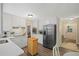 Well-lit kitchen with stainless steel appliances, white cabinets, and a breakfast nook by the doorway at 4628 Mountain Creek Ne Dr, Roswell, GA 30075