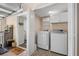 The laundry room has full-sized appliances, neutral paint and tile floors at 4628 Mountain Creek Ne Dr, Roswell, GA 30075