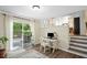Open concept room with a computer desk, sliding glass doors to deck, and steps up to the kitchen at 4628 Mountain Creek Ne Dr, Roswell, GA 30075