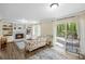 Inviting living room featuring a fireplace, built-in shelving, hardwood floors, and sliding glass doors to the outdoor deck at 4628 Mountain Creek Ne Dr, Roswell, GA 30075