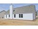 Rear exterior view of a home with a concrete patio and chimney at 494 Charleston Pl, Villa Rica, GA 30180