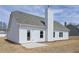 Exterior view of the back of the house with a concrete patio and chimney at 494 Charleston Pl, Villa Rica, GA 30180