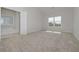 Bright bedroom with plush carpeting, natural light, and a view of the outdoors at 494 Charleston Pl, Villa Rica, GA 30180
