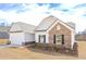 Charming home with stone accents, black shutters, a two-car garage, and a landscaped yard at 494 Charleston Pl, Villa Rica, GA 30180