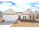 Beautiful new home features stone accents, a two-car garage, and a well-manicured lawn at 494 Charleston Pl, Villa Rica, GA 30180