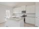 Beautiful kitchen island with stainless steel appliances and granite countertops provides additional seating and counter space at 494 Charleston Pl, Villa Rica, GA 30180