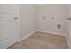 Laundry room featuring wire shelving and hookups, providing ample space for storage and convenience at 494 Charleston Pl, Villa Rica, GA 30180