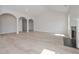 Open-concept living area with arched doorways, light floors, and a view of the fireplace at 494 Charleston Pl, Villa Rica, GA 30180