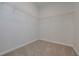 Spacious walk-in closet with carpeted flooring and installed wire shelving for optimal storage at 494 Charleston Pl, Villa Rica, GA 30180
