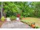 Backyard patio with seating, bordered by lush greenery and flowerbeds at 67 Lannon Ne Ave, Atlanta, GA 30317