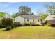 Backyard view showing the house, deck, manicured lawn, and perimeter landscaping at 67 Lannon Ne Ave, Atlanta, GA 30317