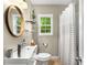 Well-lit bathroom with a sleek mirror, modern vanity, and a shower-tub combo at 67 Lannon Ne Ave, Atlanta, GA 30317