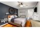 Stylish bedroom features a decorative wall, hardwood floors, and an ensuite bathroom at 67 Lannon Ne Ave, Atlanta, GA 30317