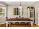 Warm dining room with rustic table, modern chairs, a stylish light fixture and lots of natural light at 67 Lannon Ne Ave, Atlanta, GA 30317
