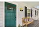 Inviting front porch features a wooden bench with pillows, a green door, and black window shutters at 67 Lannon Ne Ave, Atlanta, GA 30317
