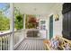 Charming front porch with a wooden bench, decorative pillows, and lush greenery, perfect for relaxation at 67 Lannon Ne Ave, Atlanta, GA 30317