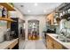 Modern kitchen featuring stainless steel appliances, light wood cabinetry, open shelving, and access to the dining room at 67 Lannon Ne Ave, Atlanta, GA 30317