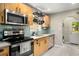 Efficient kitchen with stainless steel appliances, wood cabinets, and tiled backsplash at 67 Lannon Ne Ave, Atlanta, GA 30317