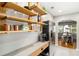 Butler's pantry with open shelving and stainless steel refrigerator adjacent to the dining room at 67 Lannon Ne Ave, Atlanta, GA 30317