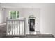 Bright entryway features a staircase with white railing, shiny floors, and a black front door at 118 Maplewood Cv, Acworth, GA 30101