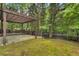 View of the landscaped backyard with pergola covered patio area at 335 Pintail Ct, Suwanee, GA 30024