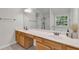 Bathroom featuring a double vanity, large mirror, and neutral color scheme at 335 Pintail Ct, Suwanee, GA 30024