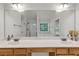 Spacious bathroom with double sink vanity, large mirror, garden tub, and shower at 335 Pintail Ct, Suwanee, GA 30024