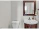 Clean half bathroom with a modern vanity, mirror, and fixtures at 335 Pintail Ct, Suwanee, GA 30024