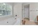 Bathroom area highlighting a garden tub and natural light from the window at 335 Pintail Ct, Suwanee, GA 30024