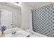 Bathroom with vanity, sink, and shower/tub combination with patterned curtain at 335 Pintail Ct, Suwanee, GA 30024