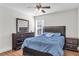 Bedroom featuring a well-made bed, dresser with mirror, and natural light at 335 Pintail Ct, Suwanee, GA 30024