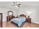 Cozy bedroom with ceiling fan, matching furniture set, and hardwood floors at 335 Pintail Ct, Suwanee, GA 30024