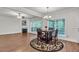 Open-concept living and dining area with hardwood floors and a fireplace at 335 Pintail Ct, Suwanee, GA 30024