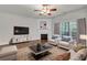 Cozy living room featuring a fireplace, stylish furniture, and large windows for ample natural light at 335 Pintail Ct, Suwanee, GA 30024