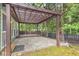 Wood patio with pergola and stone outdoor area set in a private backyard at 335 Pintail Ct, Suwanee, GA 30024