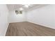 Spacious basement featuring wood-look floors and natural light from windows at 535 Silver Pine Trl, Roswell, GA 30076