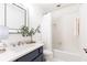 Bright bathroom featuring modern vanity with sleek fixtures, shower-tub combo with white tiles at 535 Silver Pine Trl, Roswell, GA 30076