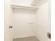 Clean white closet featuring two shelves and neutral carpet for organized storage at 535 Silver Pine Trl, Roswell, GA 30076